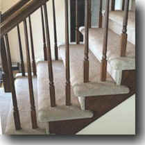Flight of Stairs with spindles and double-wrapped carpet.